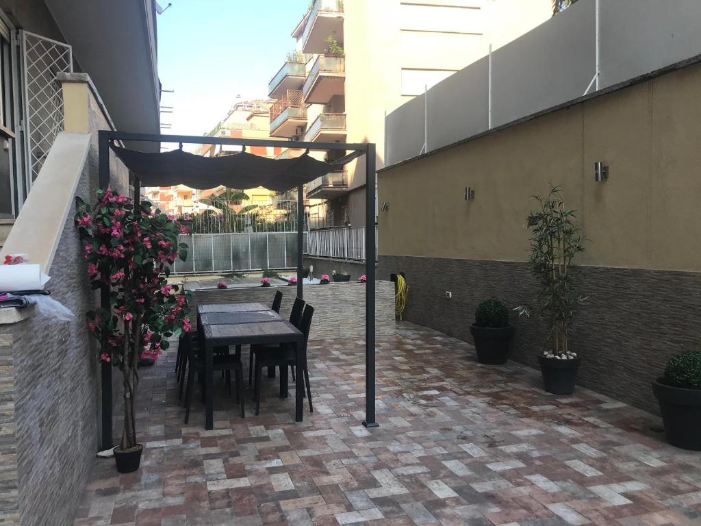 Private terrace with pergola, dining table and planting