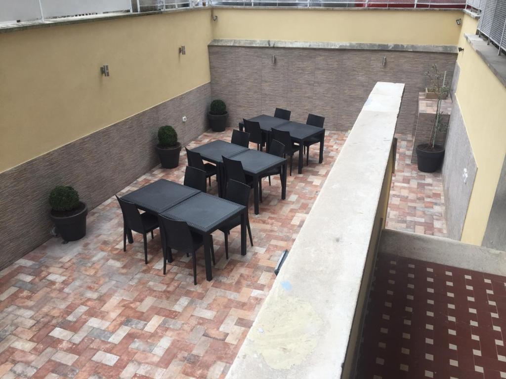 Paved outdoor patio with outdoor dining tables