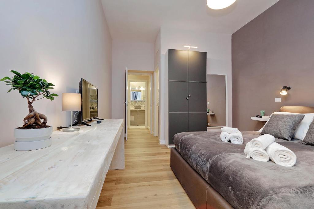 Double bedroom with television and plant on a console