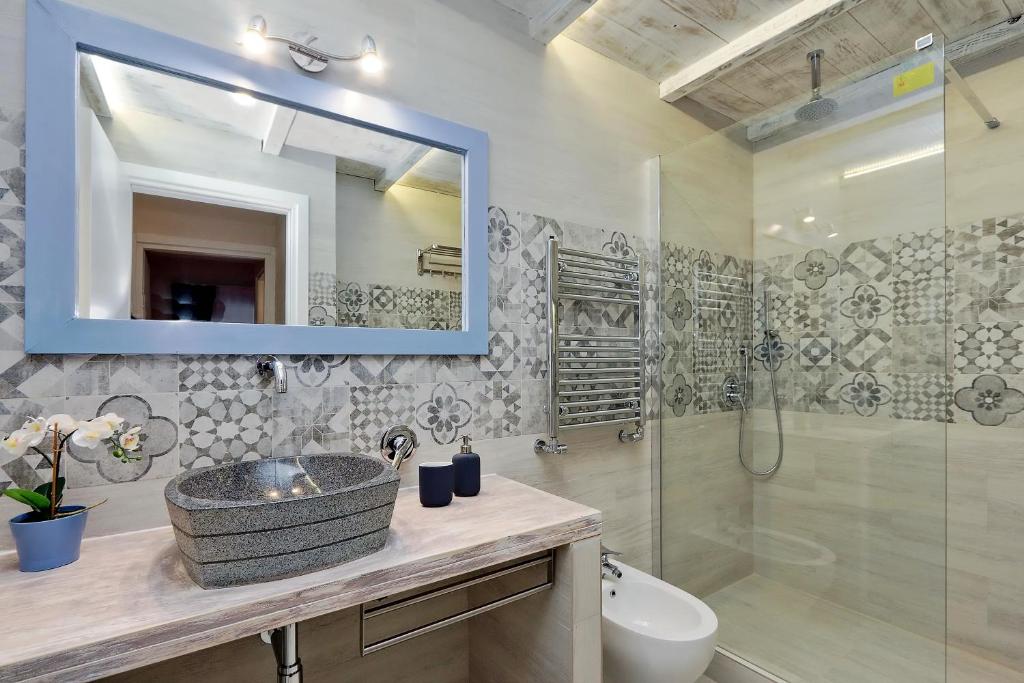 Bathroom with stone basin, decorative tiling and walk-in shower