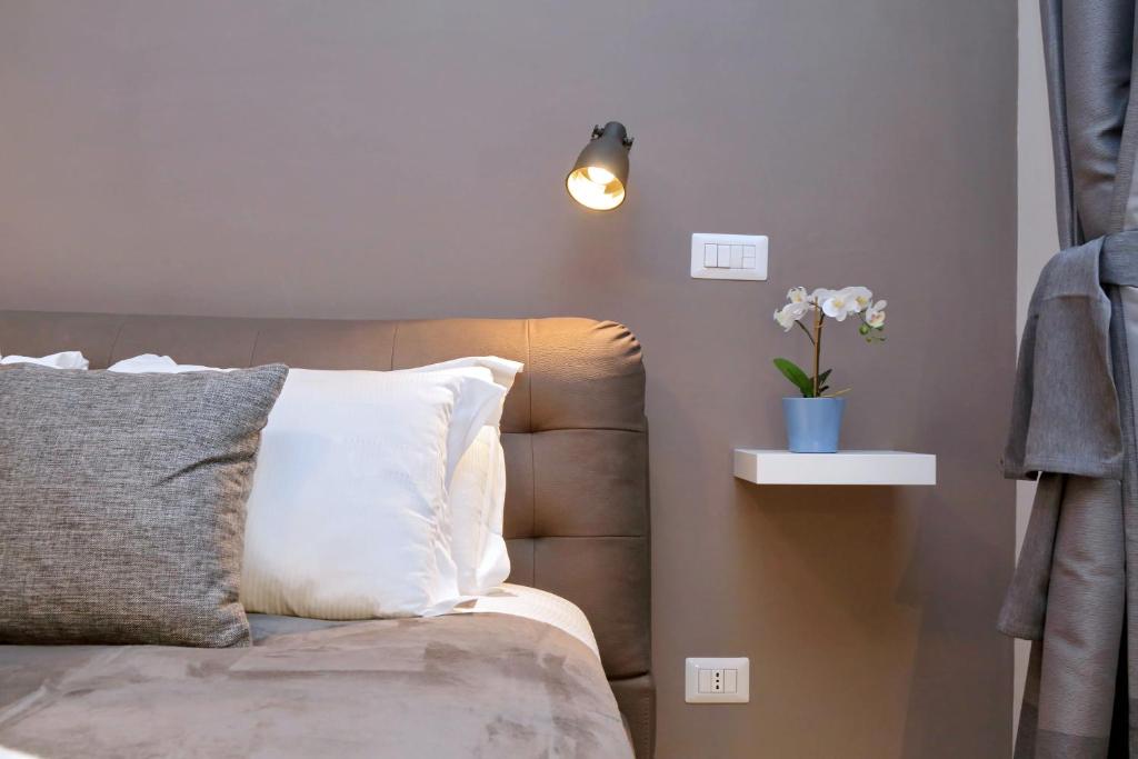 Upholstered headboard, reading lamp and orchid